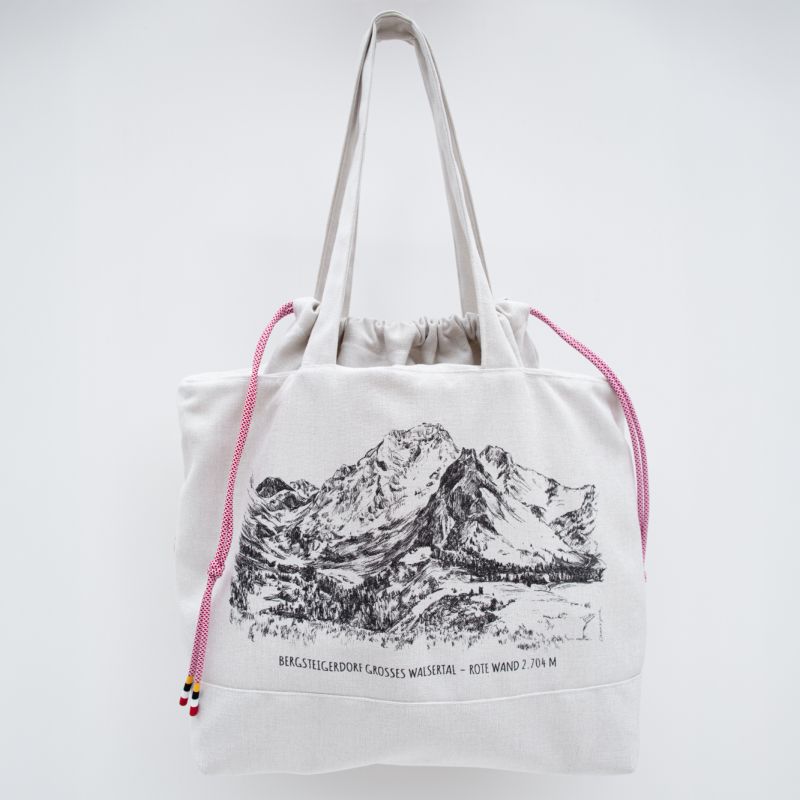 White fabric shoulder bag displaying an Alpine landscape illustration