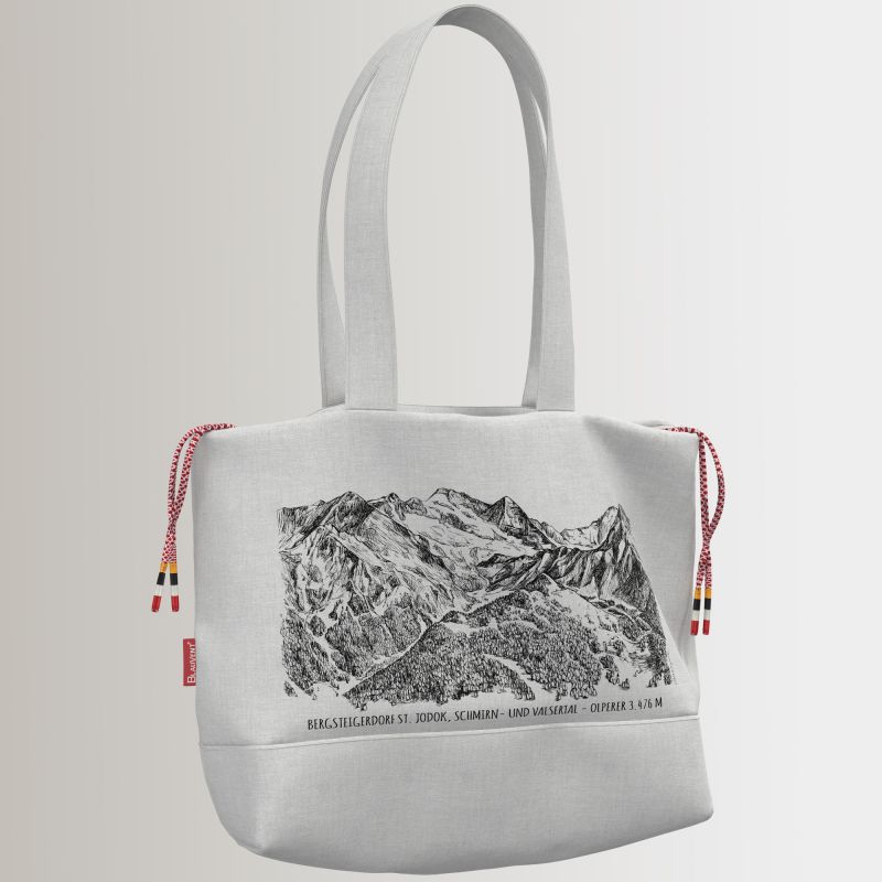 Light-coloured fabric shoulder bag printed with a rocky mountain landscape