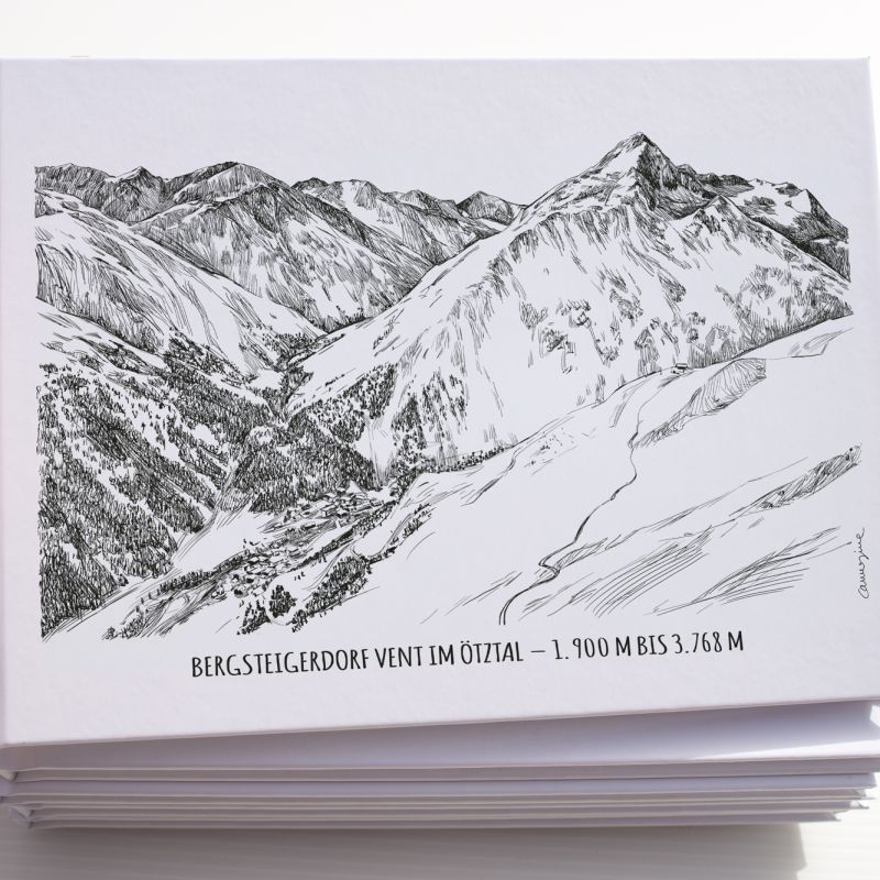 Stack of postcards with a printed illustration of snowy mountain peaks