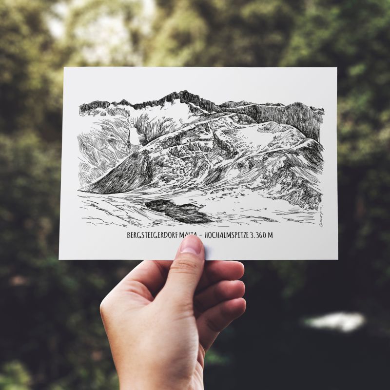 Hand holding an illustrated mountain destination postcard outdoors