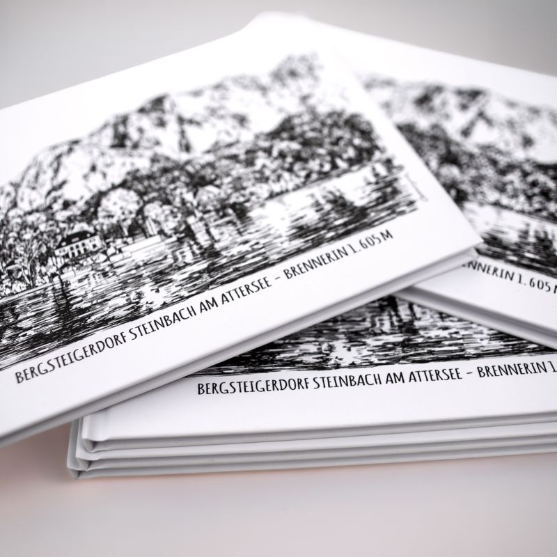 Stack of mountain illustration postcards arranged on a tabletop