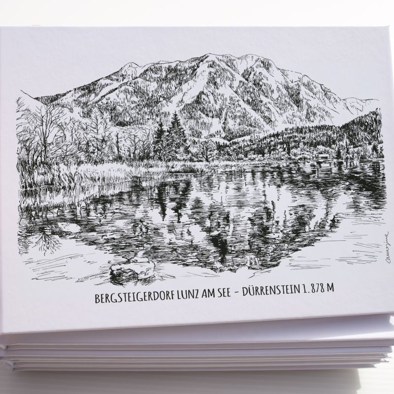 Stack of illustrated Alpine destination postcards held in one hand