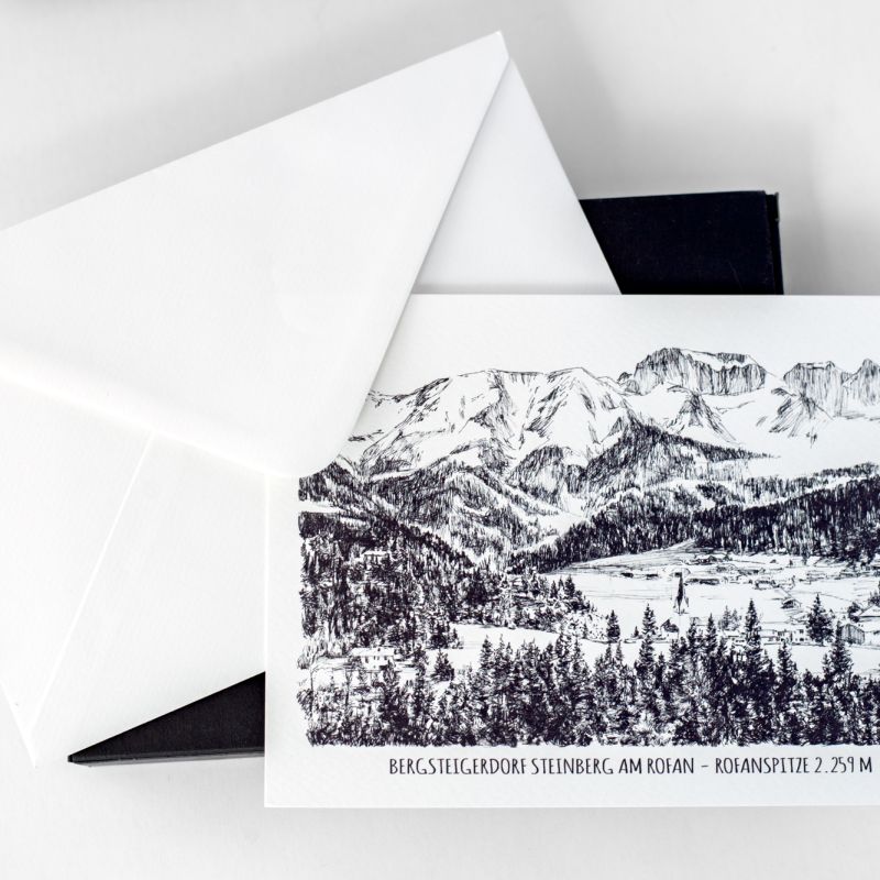 Mountain landscape postcard displayed with a white envelope