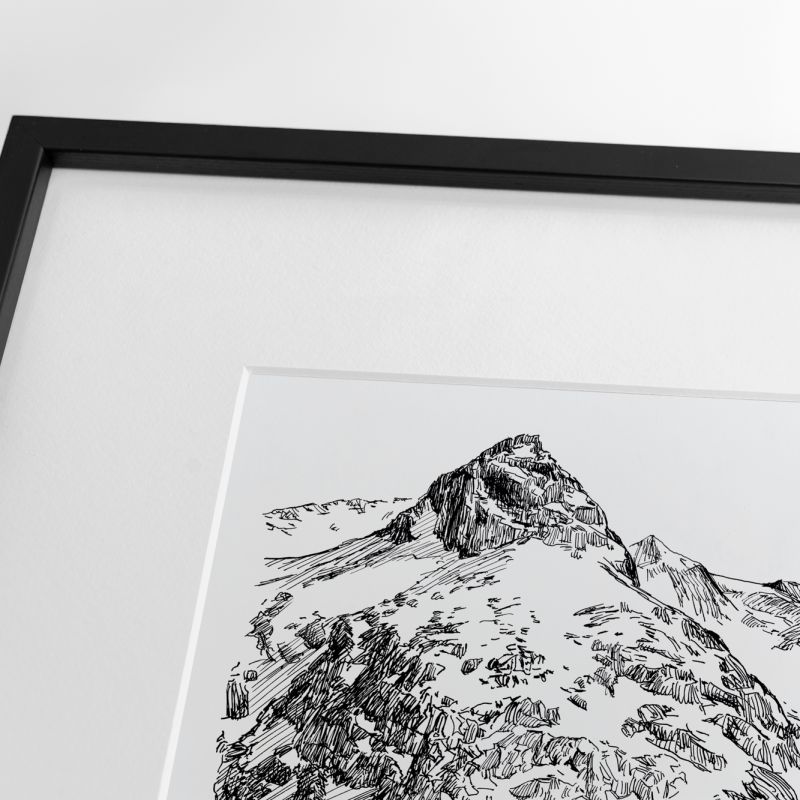 Close-up of a framed black ink illustration showing a rocky Alpine summit