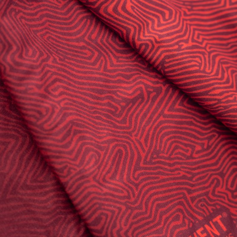 Macro textile detail of red and burgundy topographic contour-line print on a neckwarmer.