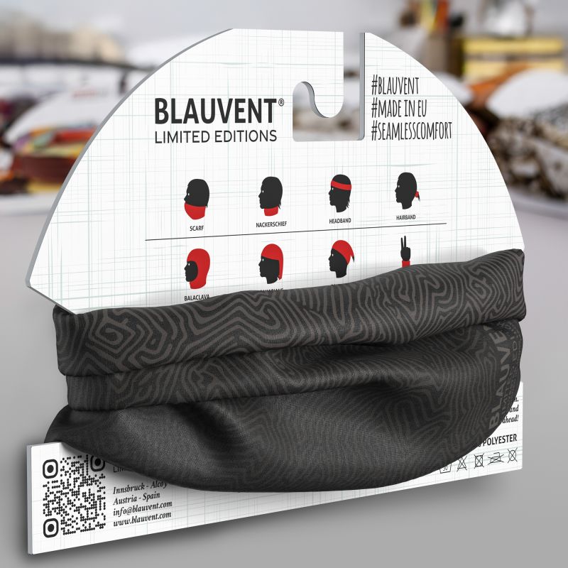 Black and grey topographic-pattern neckwarmer folded on its printed retail packaging.
